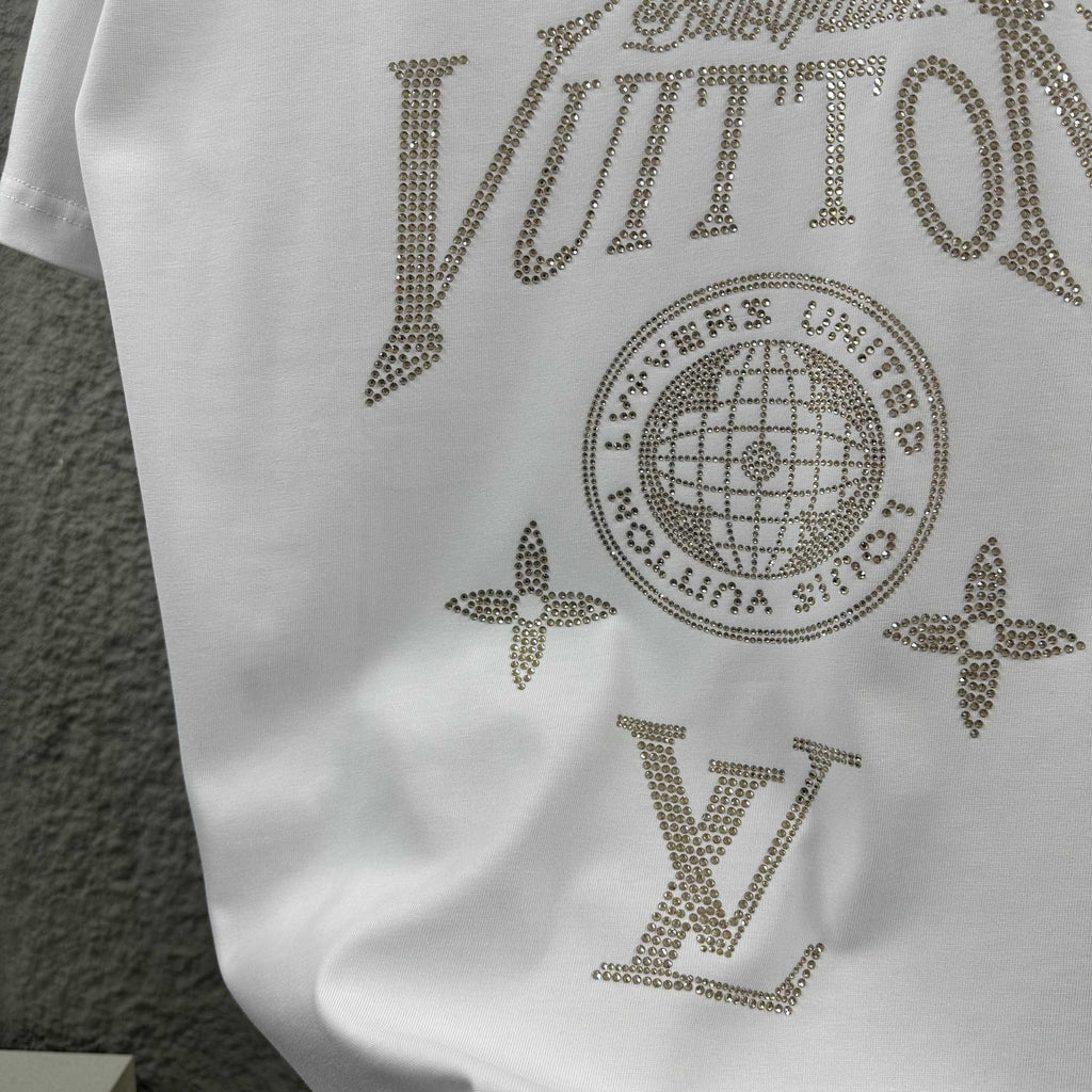 Close-up of white Louis Vuitton T-shirt rhinestone globe, stars, and LV lettering