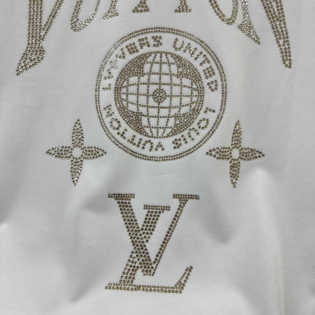 Close-up of white Louis Vuitton T-shirt rhinestone globe, stars, and LV letters