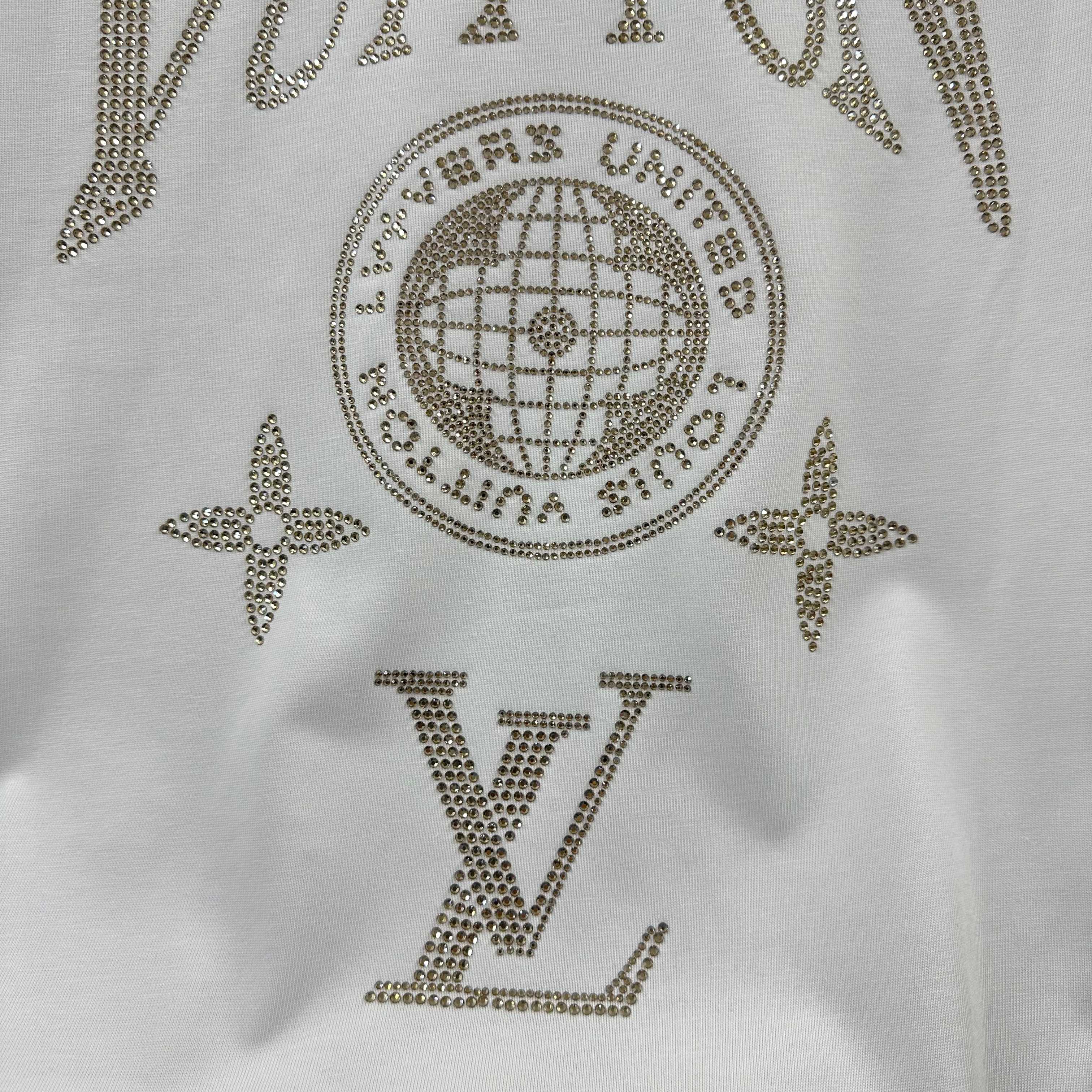 Close-up of white Louis Vuitton T-shirt rhinestone globe, stars, and LV letters