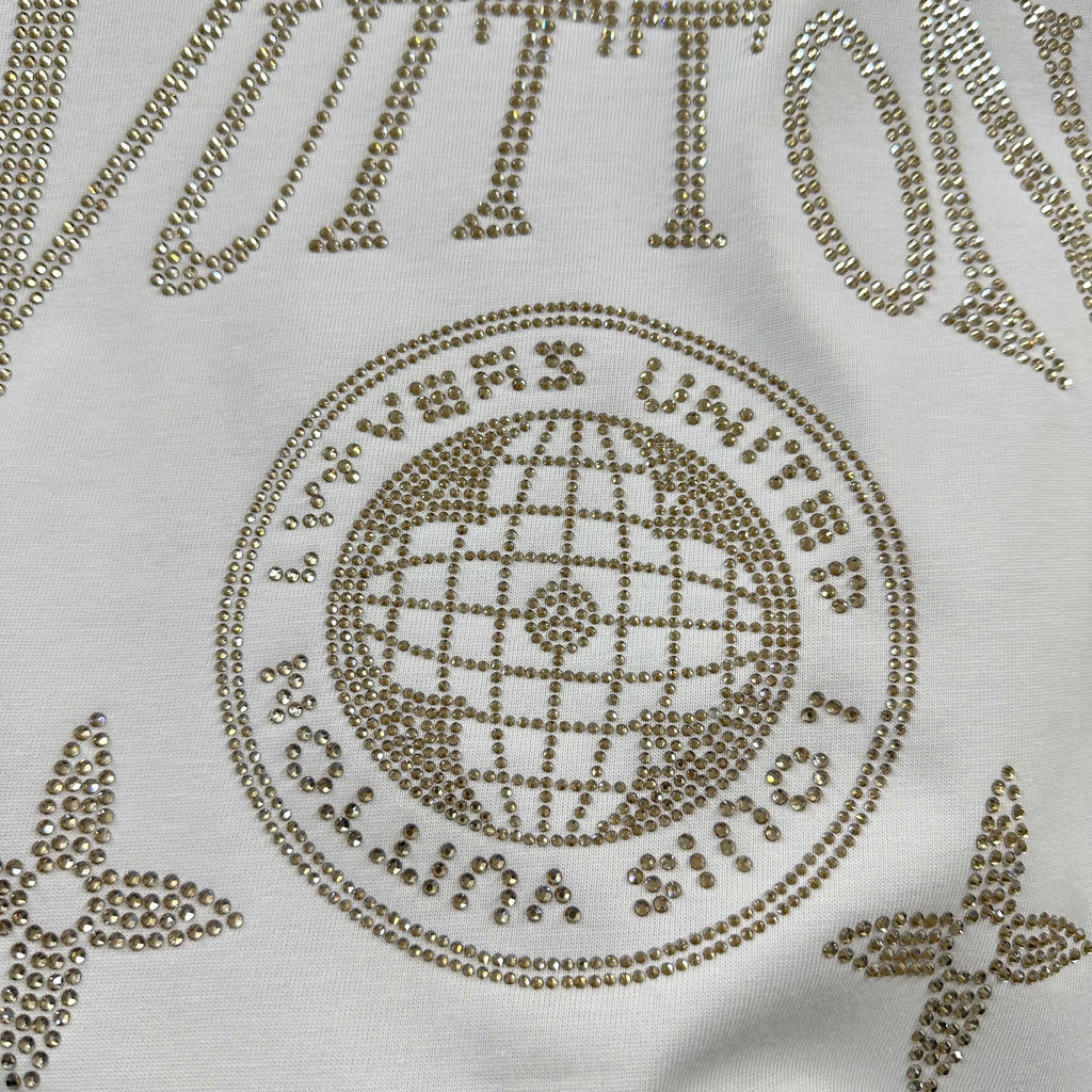 Close-up of Louis Vuitton T-shirt rhinestone globe emblem with dotted trim