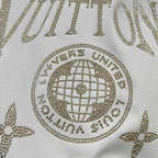 Close-up of Louis Vuitton T-shirt rhinestone globe emblem with dotted trim