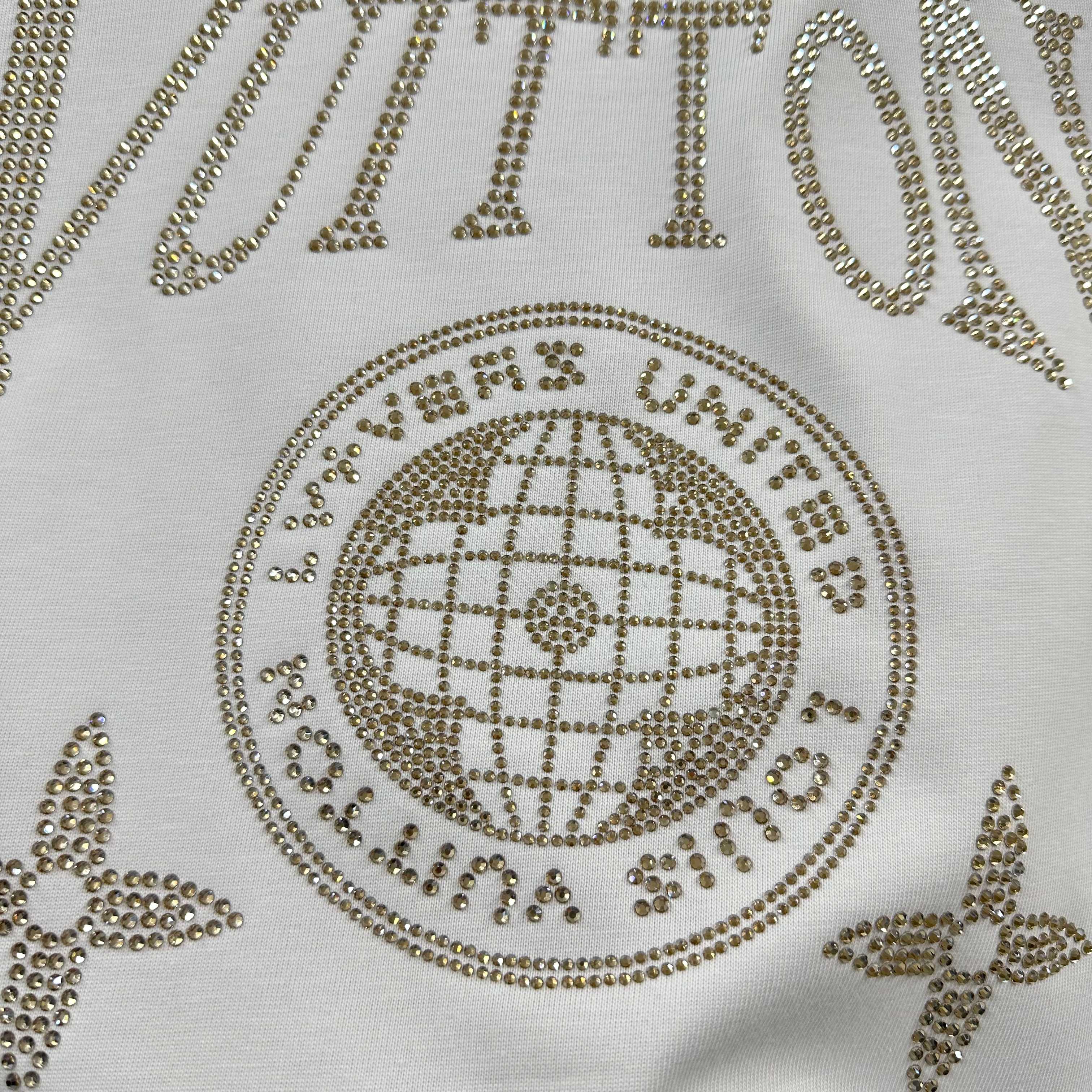 Close-up of Louis Vuitton T-shirt rhinestone globe emblem with dotted trim