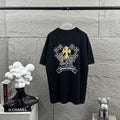 Dark T-shirt with large cross-flower graphic and banner print