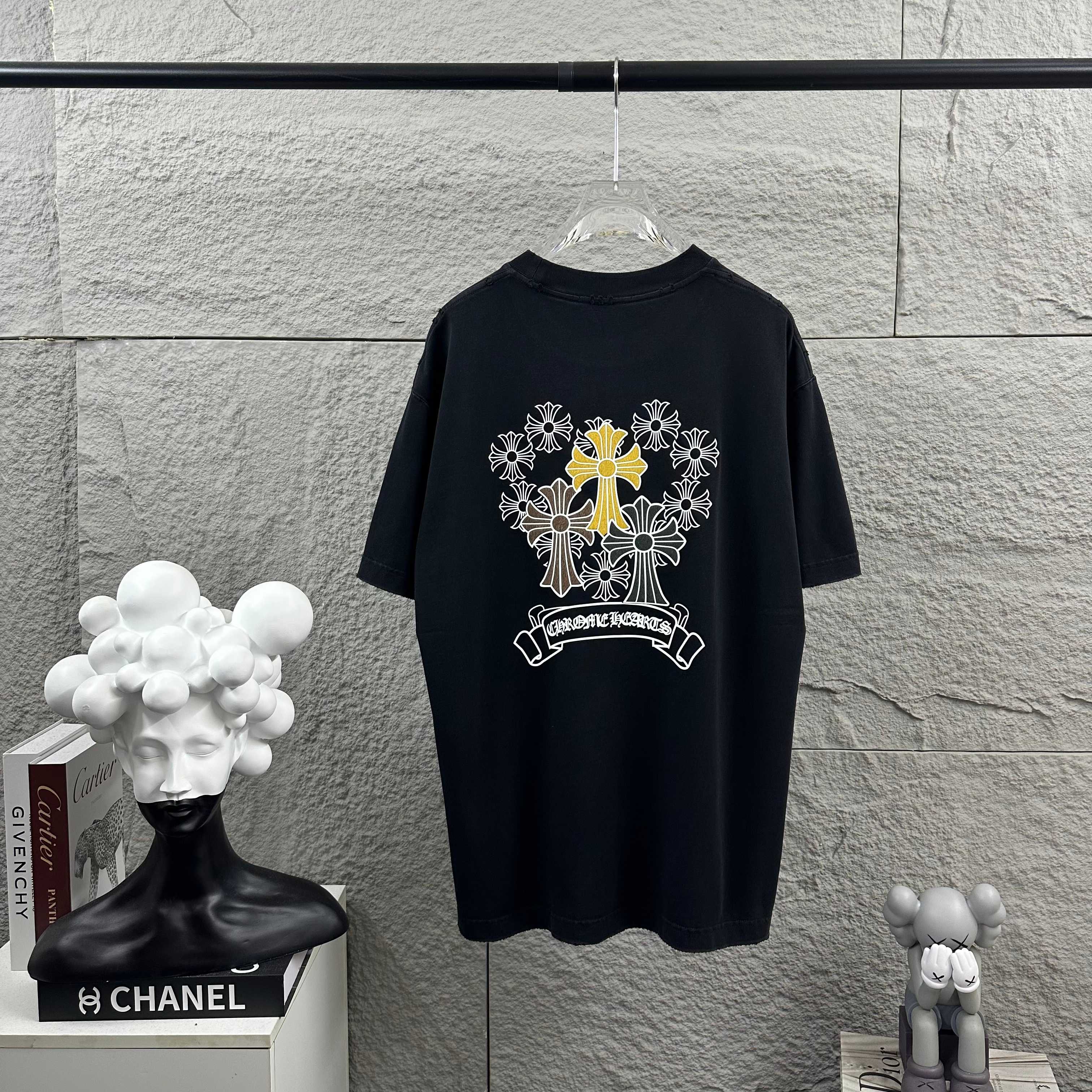 Dark T-shirt with large cross-flower graphic and banner print