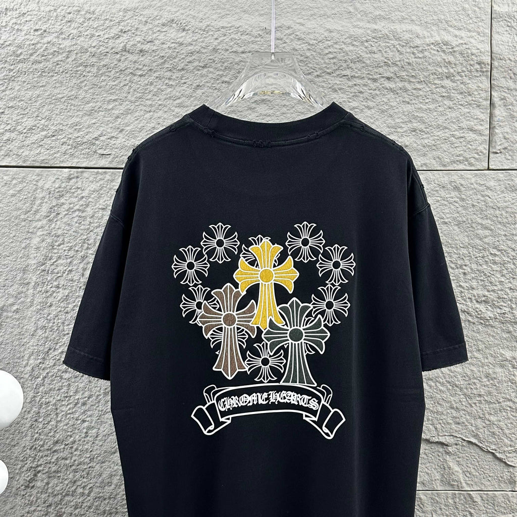 Dark T-shirt showing large cross-flower graphic with ribbon banner