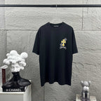 Dark T-shirt with small cross-flower logo graphic at chest