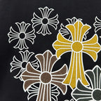 Dark T-shirt close-up of cross-flower graphic with golden center