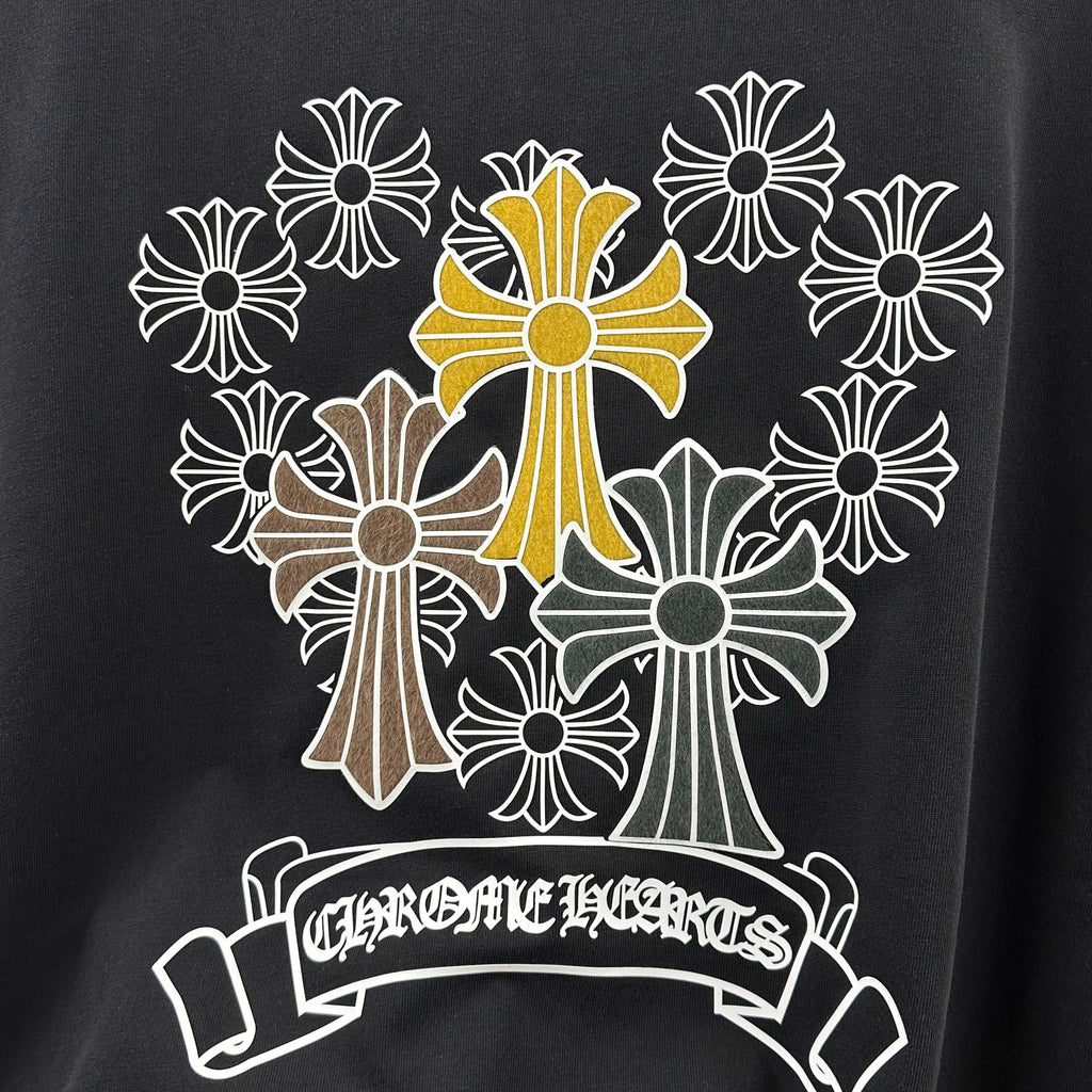 Dark T-shirt with large cross-flower wreath and banner print detail