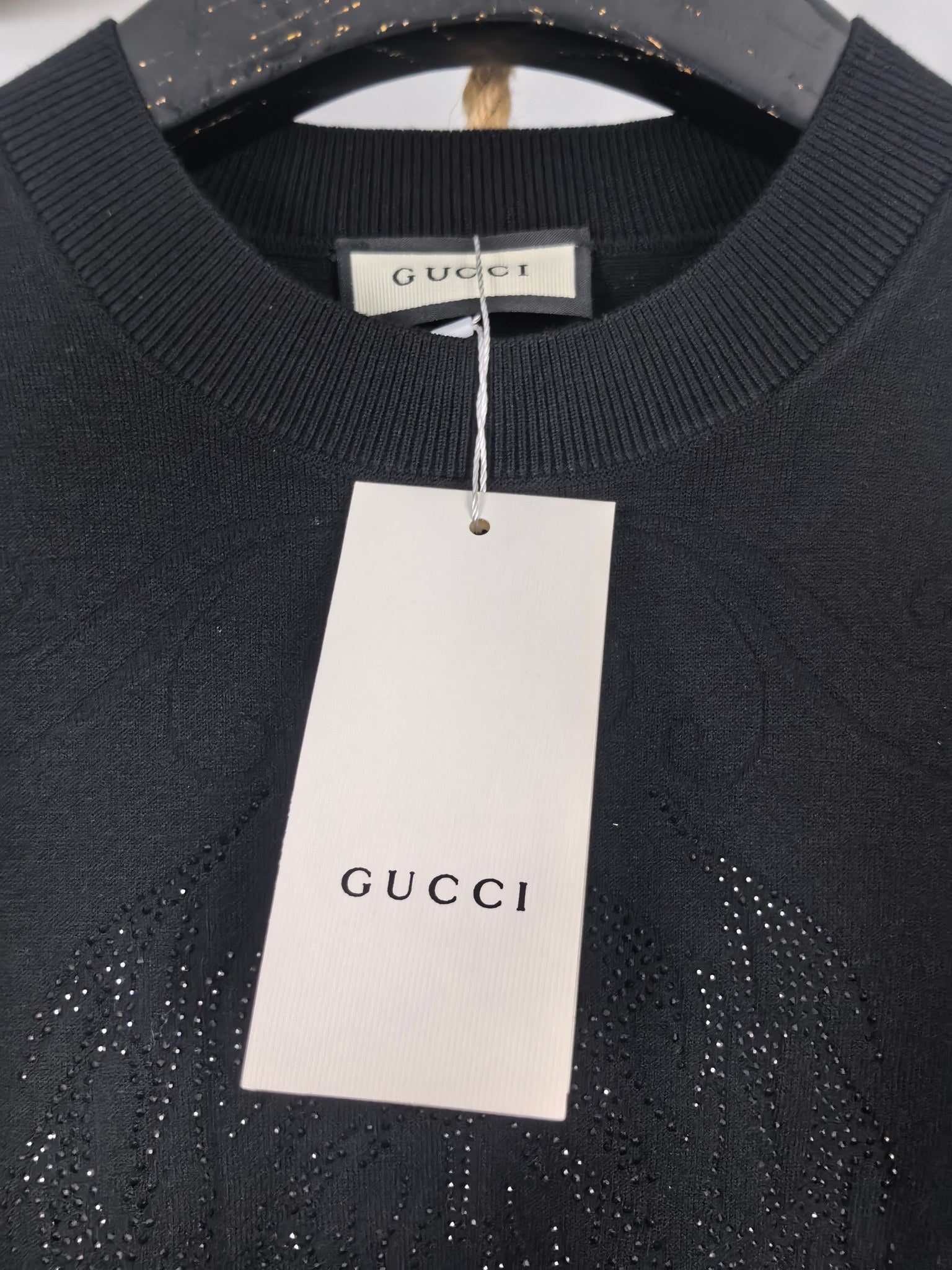 Gucci long-sleeve sweater with hanging white size tag and ribbed collar