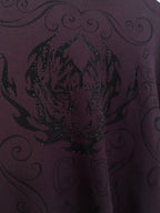 Front graphic on dark plum crewneck sweater with glittering sequin texture and scrolls