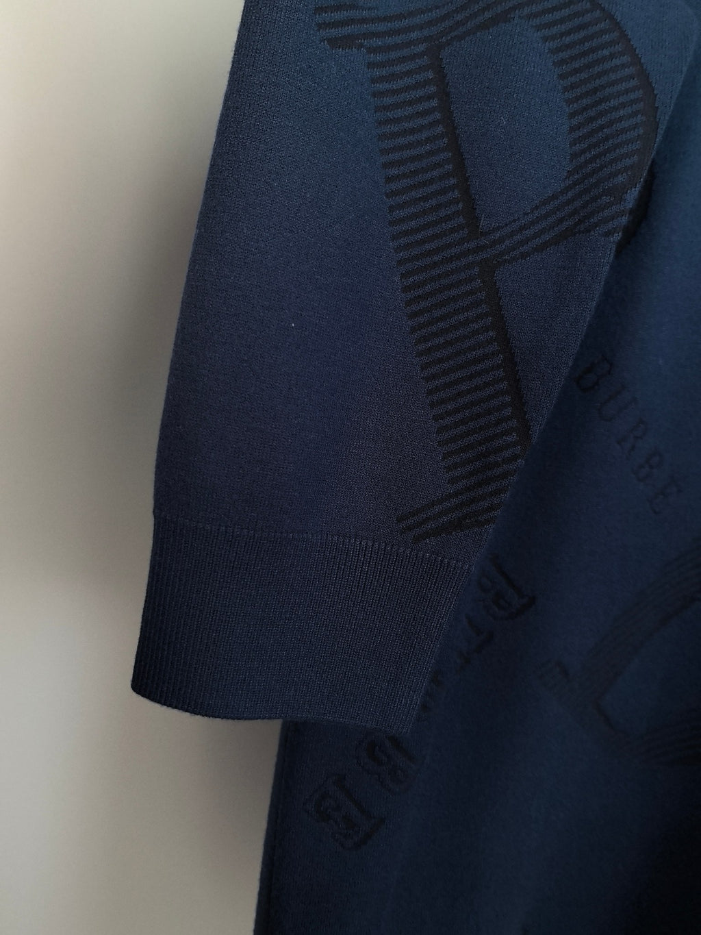 Burberry long-sleeve sweater back view, ribbed hem, and embroidered logo pattern.