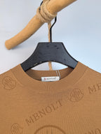 Tan knit sweater neckline with ribbed collar and Moncler logo patch inside collar