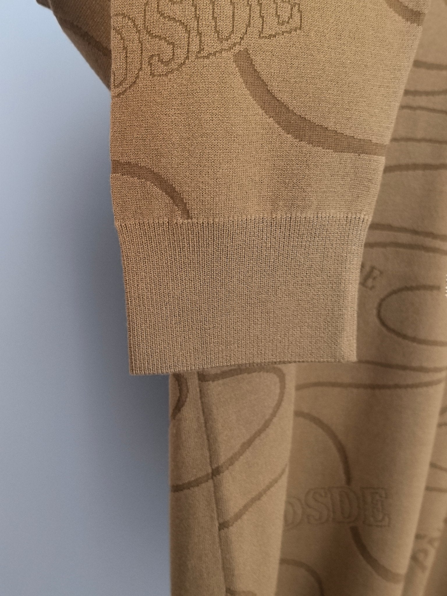 Tan Ralph Lauren sweater hem and side panel with allover graphic print