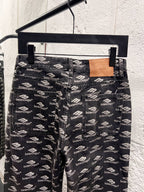 Balenciaga logo-print denim pants on hanger, relaxed straight-leg fit
