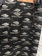 Balenciaga logo-print fabric on black denim pants, close-up