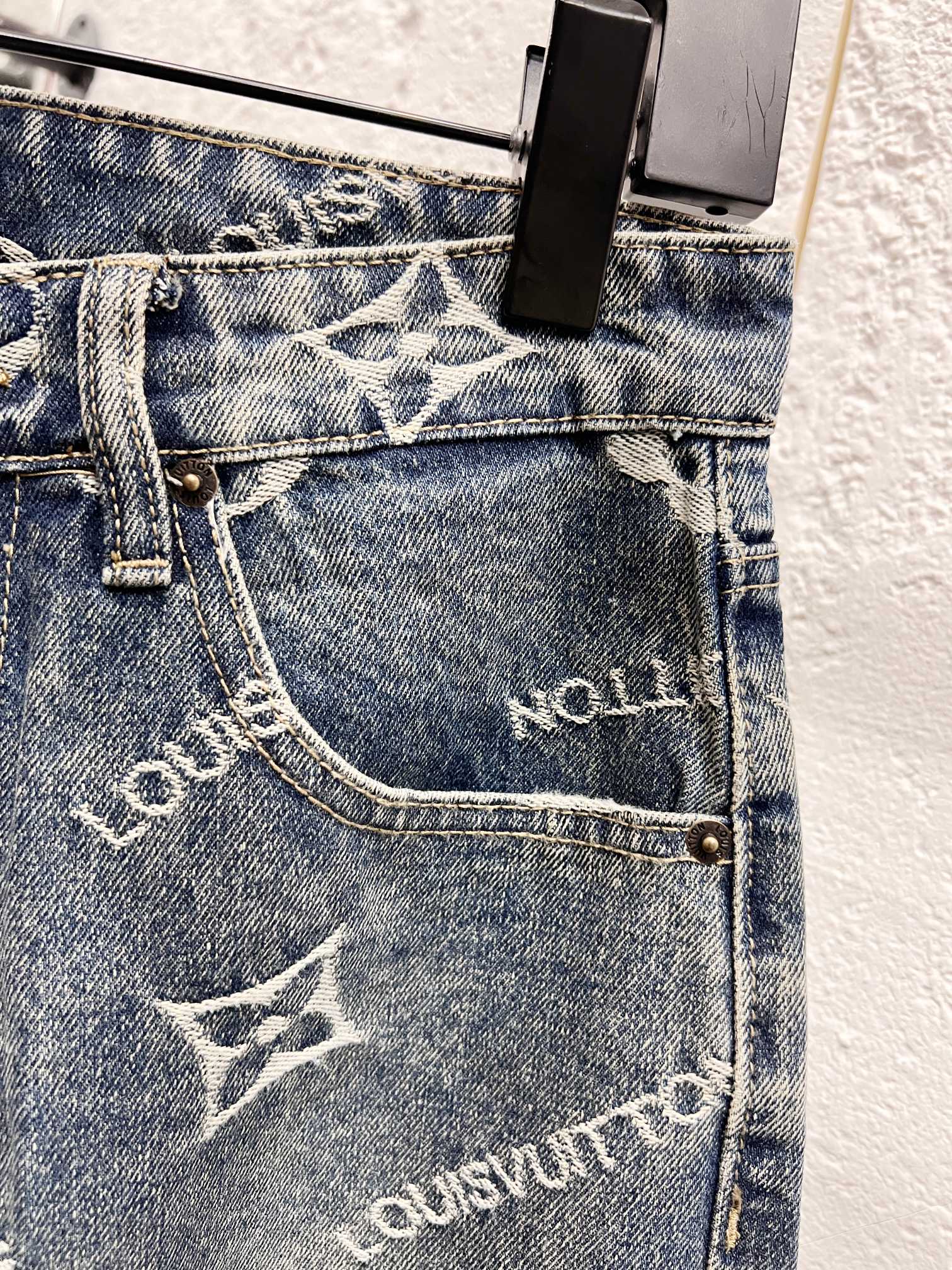 Front pocket area on light blue denim with white Louis Vuitton monogram print