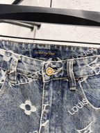 Waistband close-up with Louis Vuitton logo patch on light blue denim