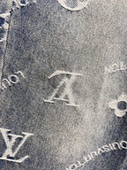 Close-up of blue denim fabric with white Louis Vuitton monogram motifs