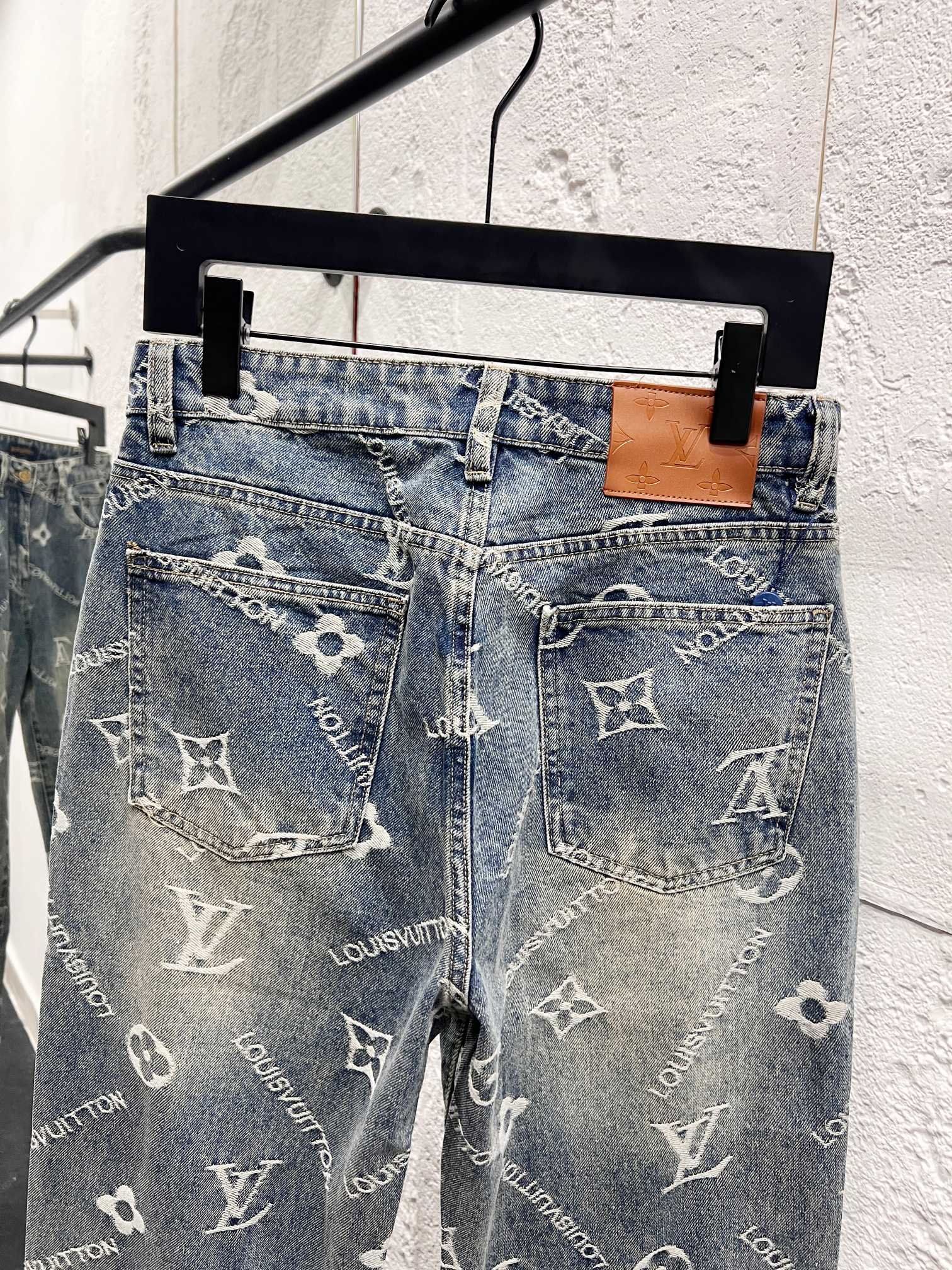 Light blue denim pants with front pockets and scattered white Louis Vuitton monogram