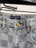 Louis Vuitton monogram jeans waistband close-up with logo patch and button fly