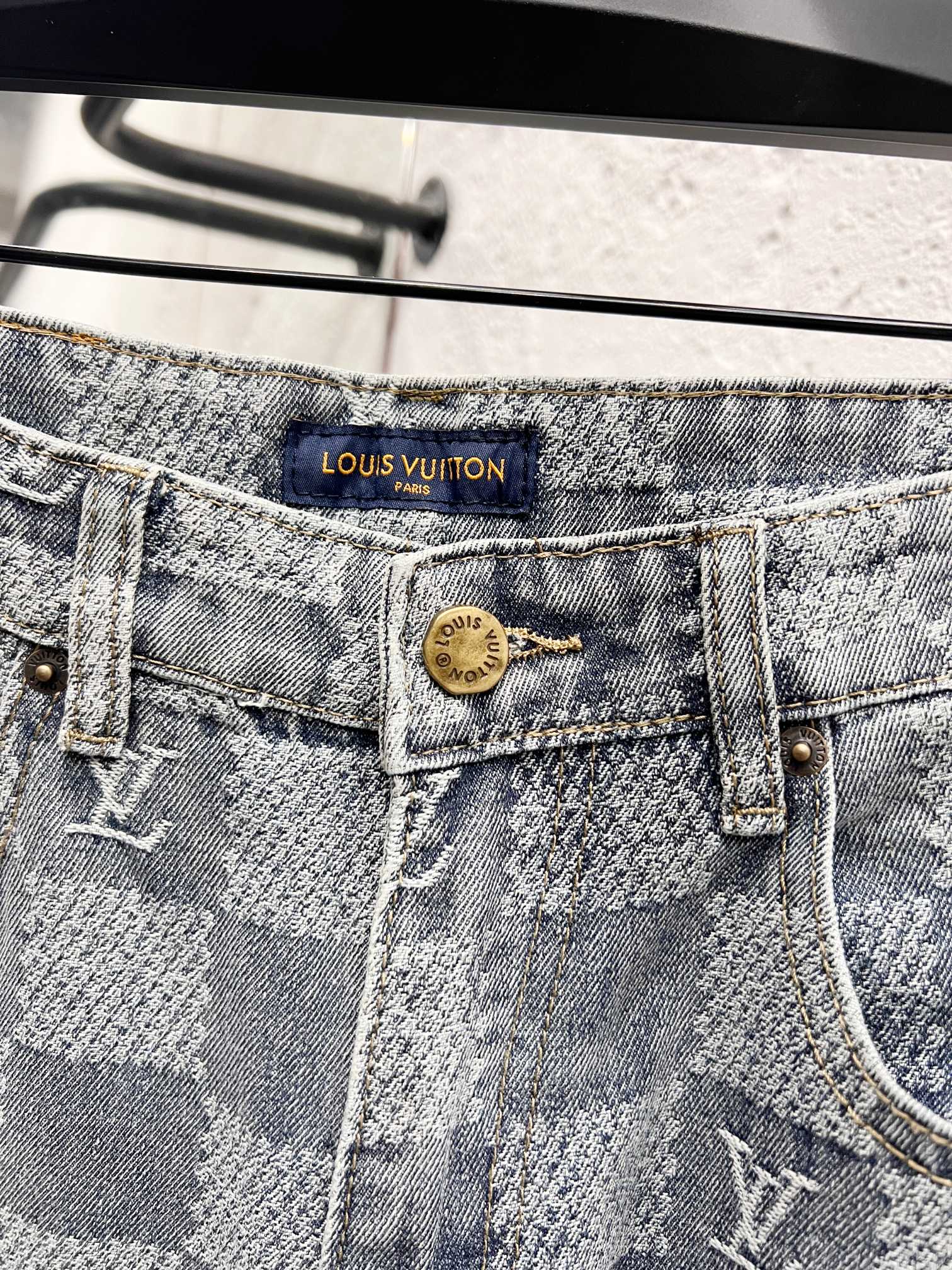 Louis Vuitton monogram jeans waistband close-up with logo patch and button fly