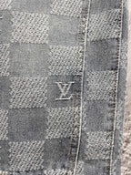 Louis Vuitton monogram denim close-up with stitched checker blocks and logo