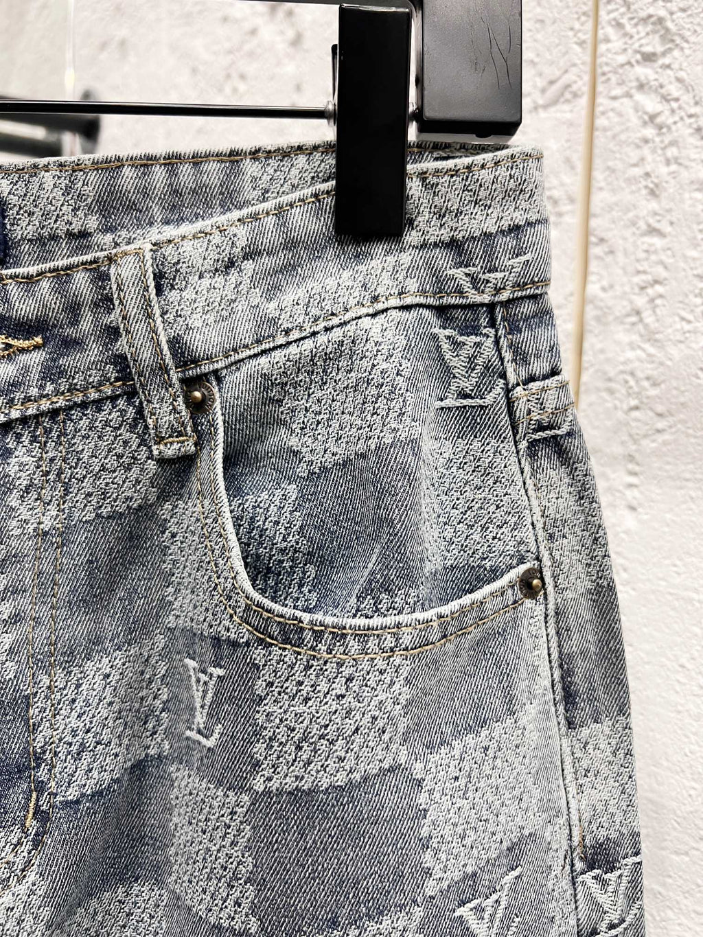 Louis Vuitton monogram jeans front close-up with patch pocket and belt loops