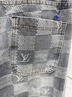 Louis Vuitton monogram jeans pocket close-up with stitched logo and checker weave