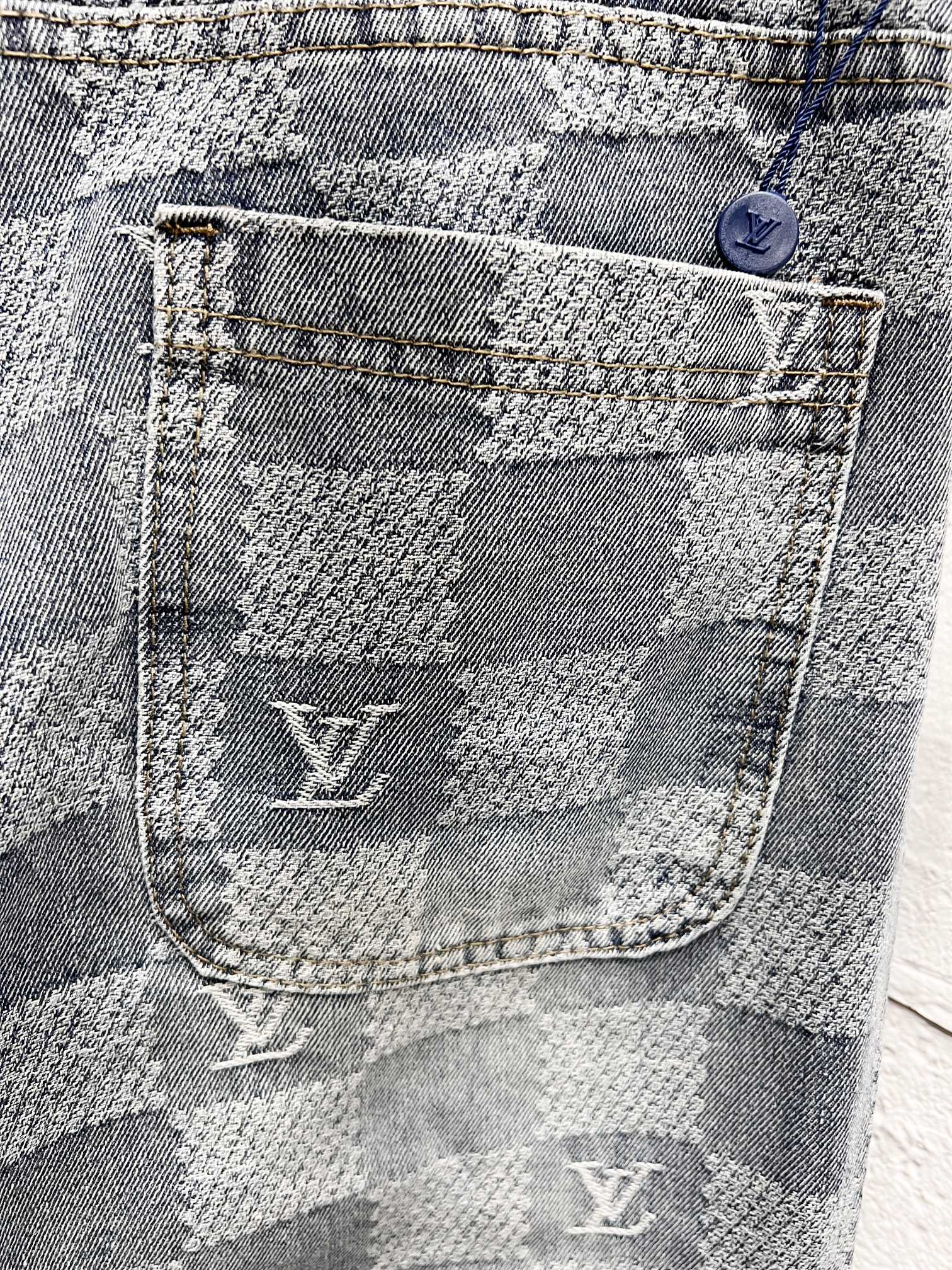 Louis Vuitton monogram jeans pocket close-up with stitched logo and checker weave