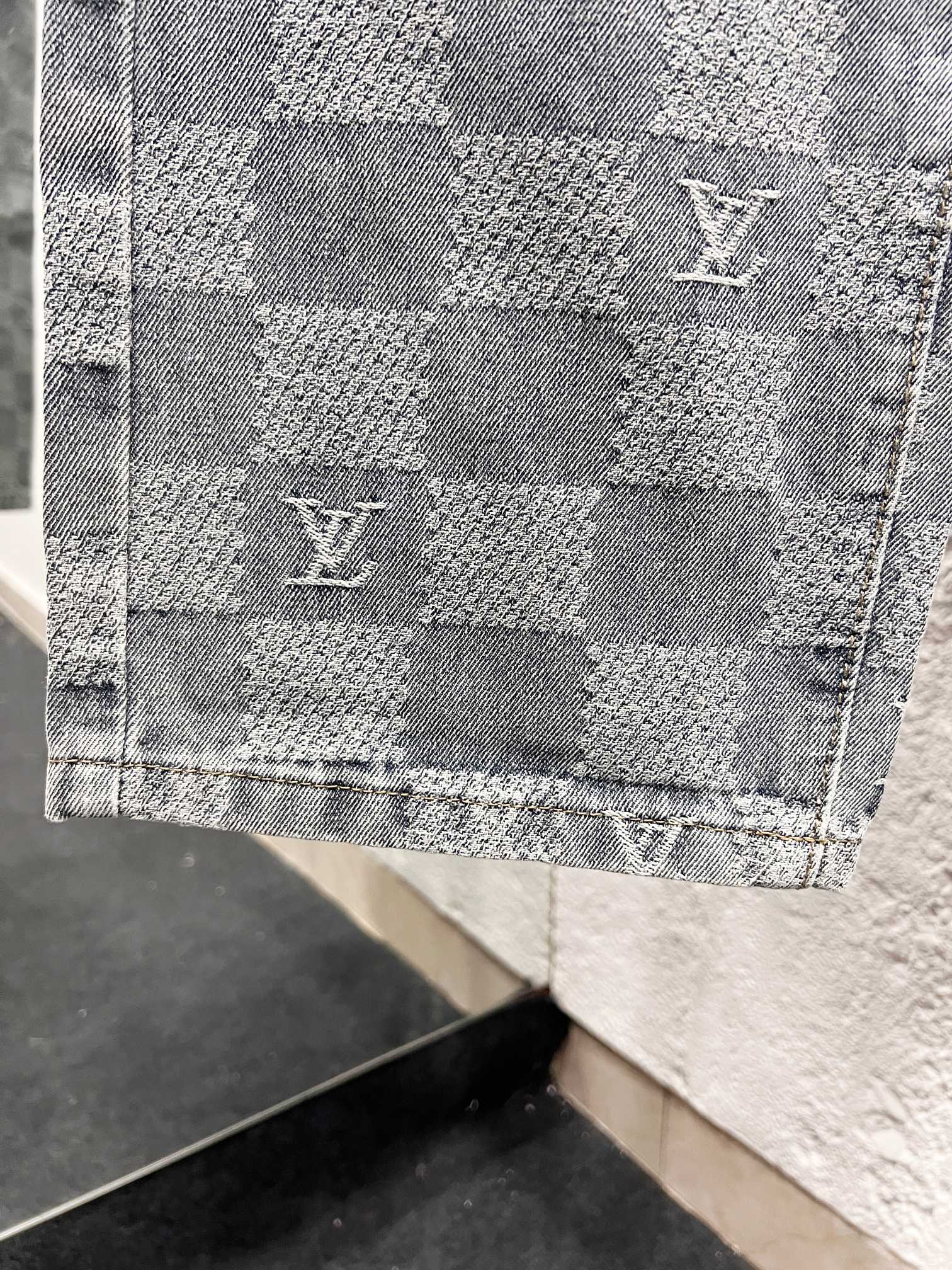 Louis Vuitton monogram denim panel detail with repeating checker pattern