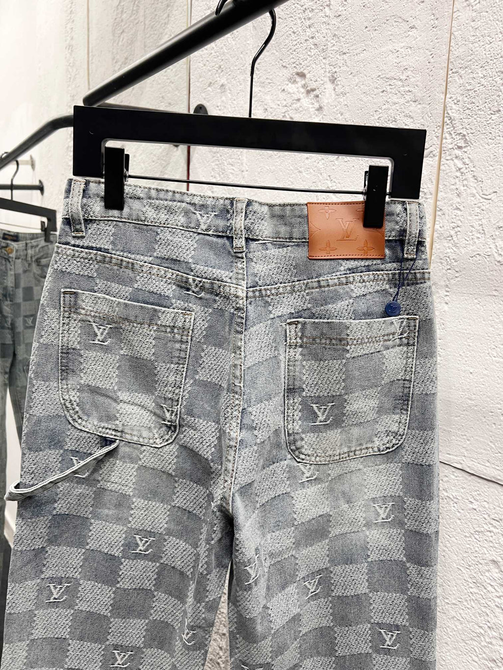 Louis Vuitton monogram jeans back view with dual patch pockets and logo markings