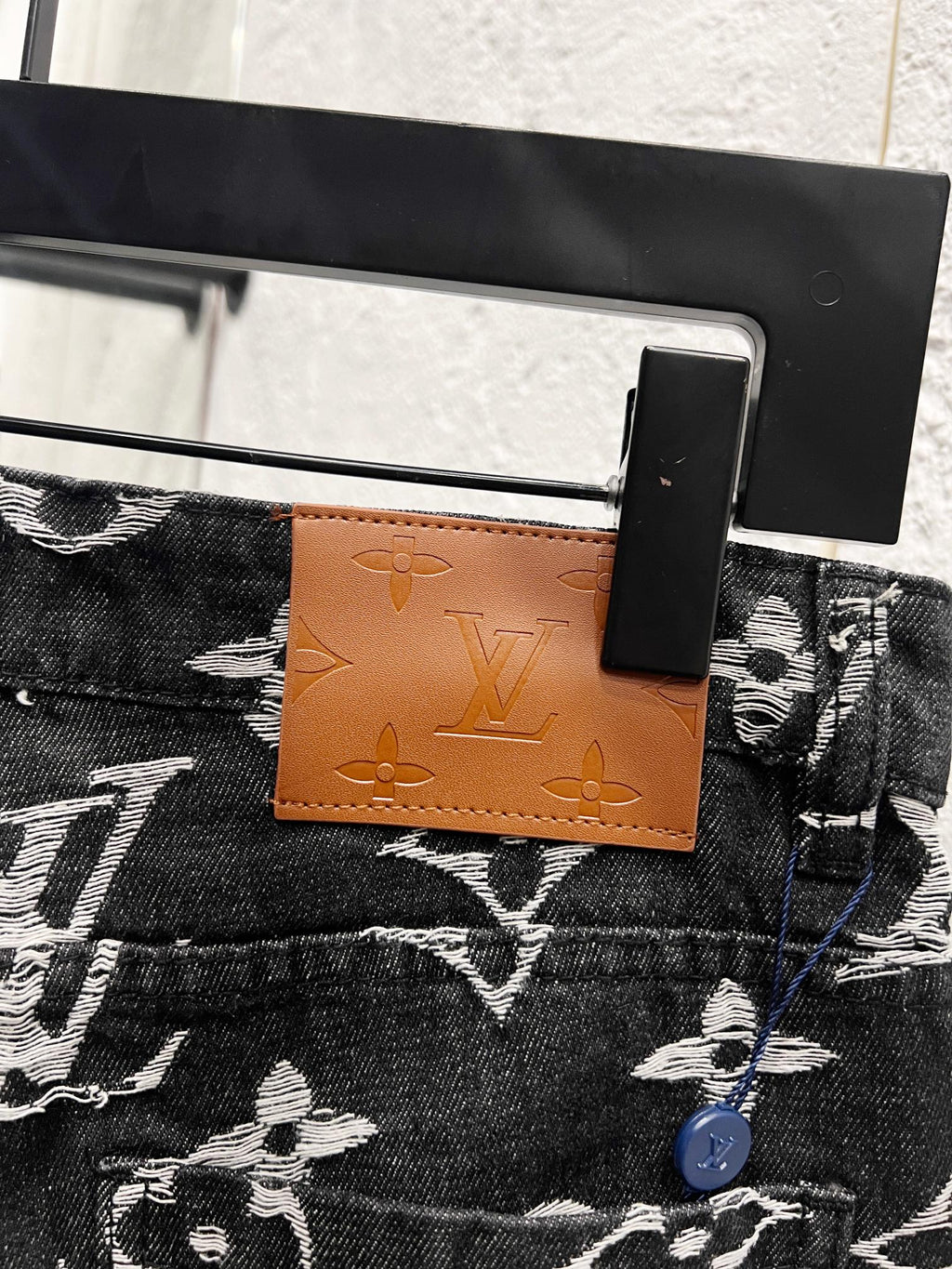 Louis Vuitton pants waist tag and button detail, dark denim with white monogram print