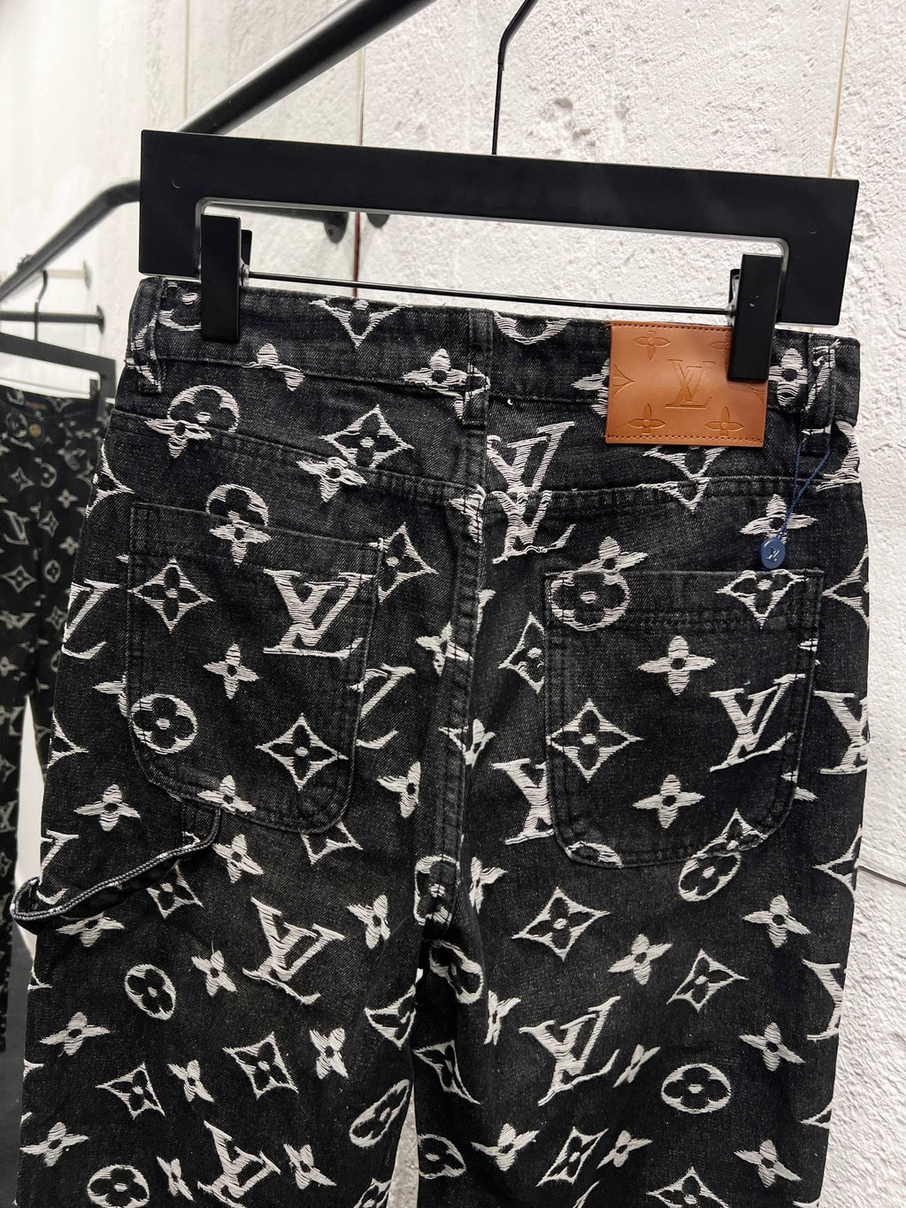 Louis Vuitton monogram print jeans with belt loops, dark fabric with white logo pattern