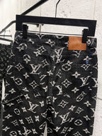 Louis Vuitton monogram print jeans with belt loops, dark fabric with white logo pattern