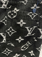 Louis Vuitton monogram print pants front detail, dark fabric with white scattered symbols