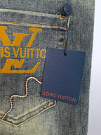 Denim pocket with large LV graphic and hanging Louis Vuitton tag, close-up