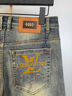 Denim pants with leather waistband patch and large printed pocket logo, back view