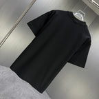 Black Gucci short-sleeve T-shirt plain design, angled view on a hanger