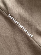 Beige long-sleeve polo with contrast zigzag stitch