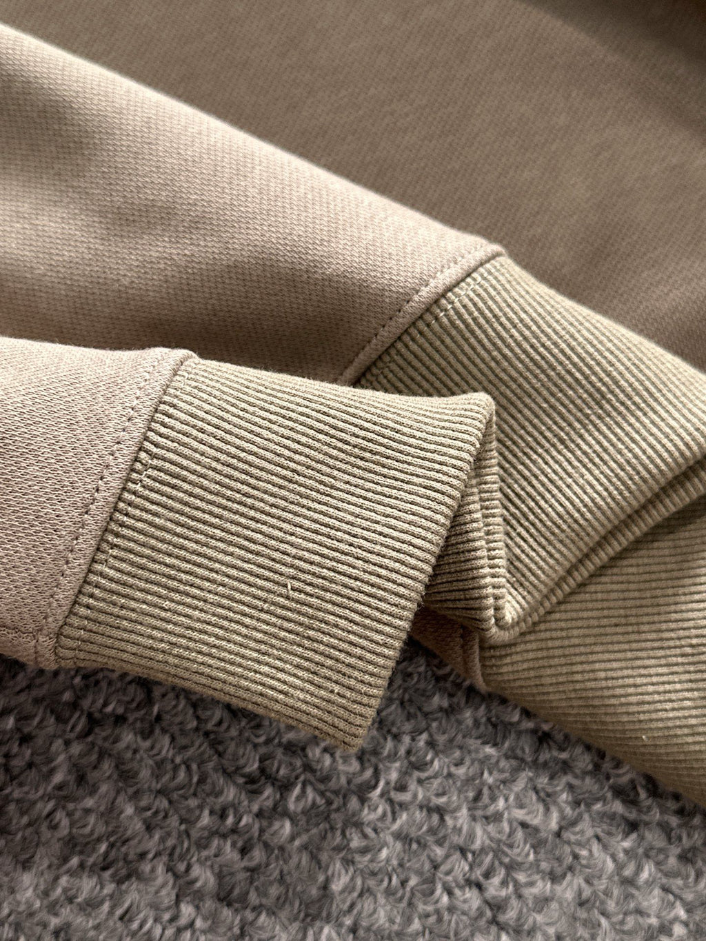 Beige ribbed cuff detail on long-sleeve polo