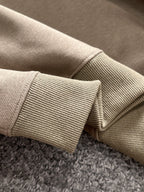 Beige ribbed cuff detail on long-sleeve polo