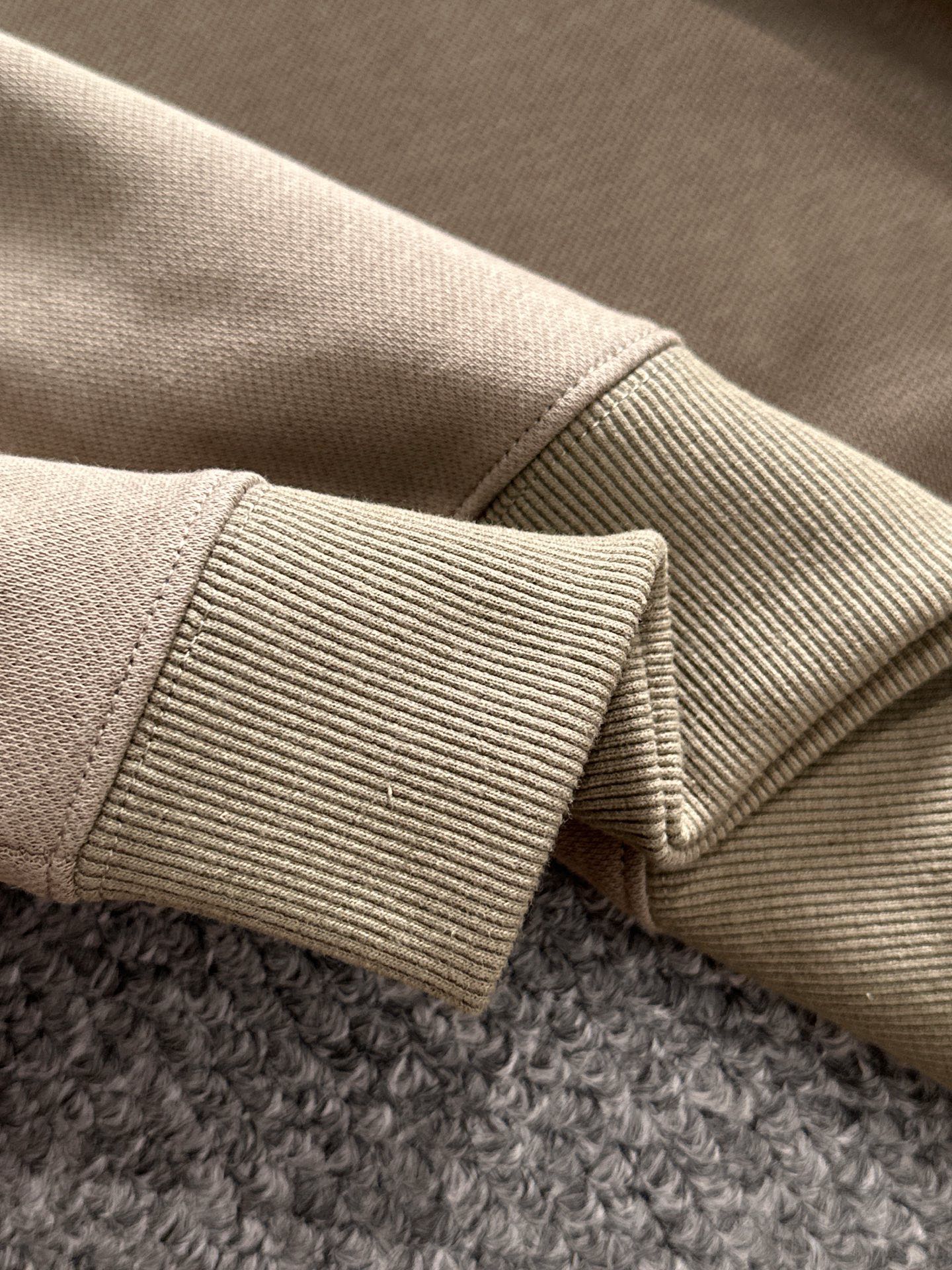 Beige ribbed cuff detail on long-sleeve polo