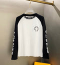 Baseball raglan long-sleeve shirt, white body with black sleeves and circular chest logo.