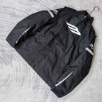 Black zip-up jacket with white Balenciaga emblem and stitched logo details