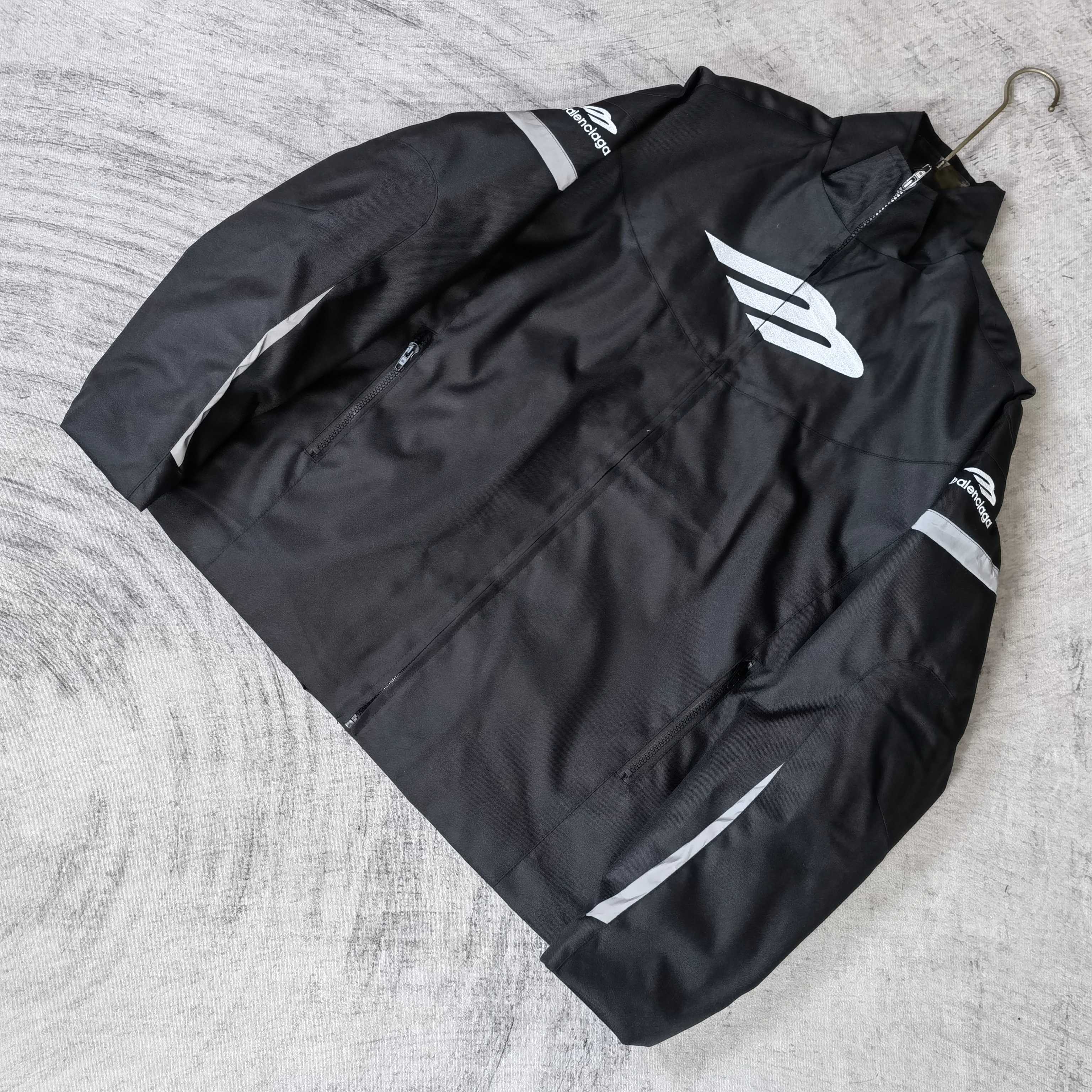 Black zip-up jacket with white Balenciaga emblem and stitched logo details