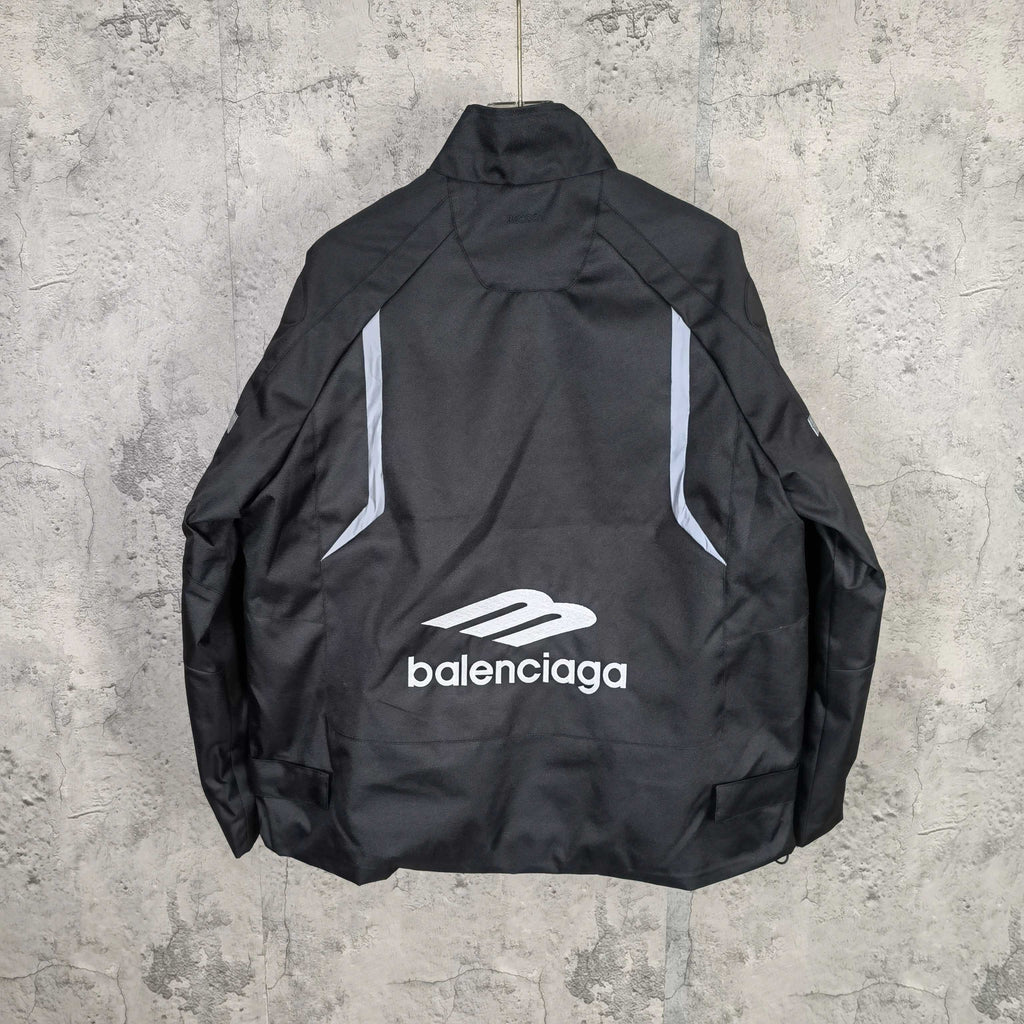 Black zip-up jacket, back view with white Balenciaga logo and “balenciaga” text
