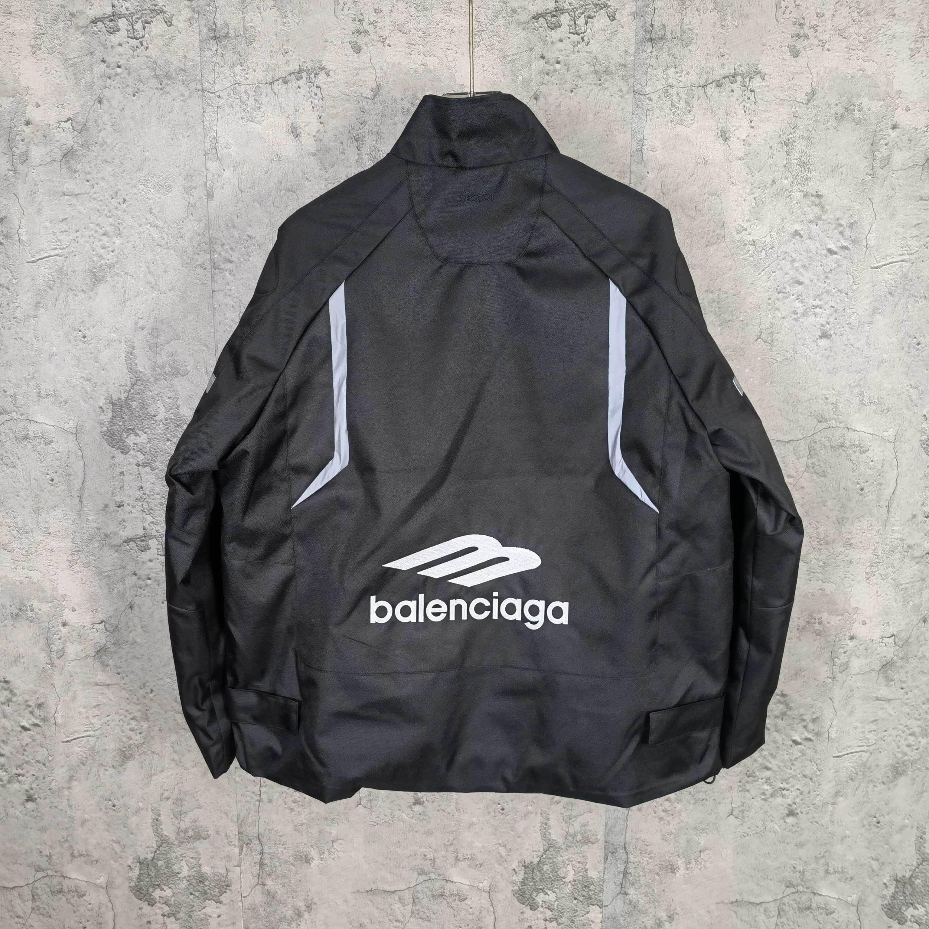 Black zip-up jacket, back view with white Balenciaga logo and “balenciaga” text