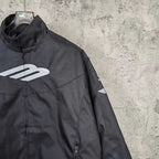 Black jacket side view with white Balenciaga emblem and front zipper detail