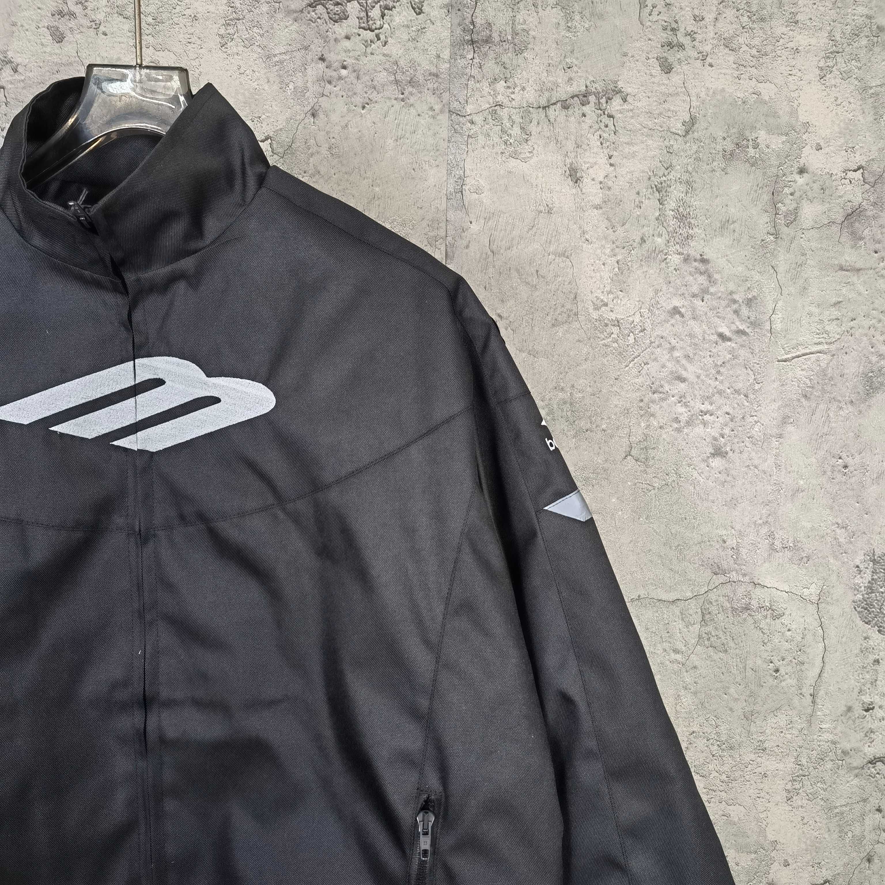 Black jacket side view with white Balenciaga emblem and front zipper detail