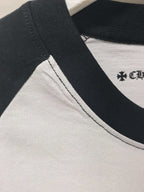 Raglan sleeve seam and ribbed collar on white T-shirt with black trim